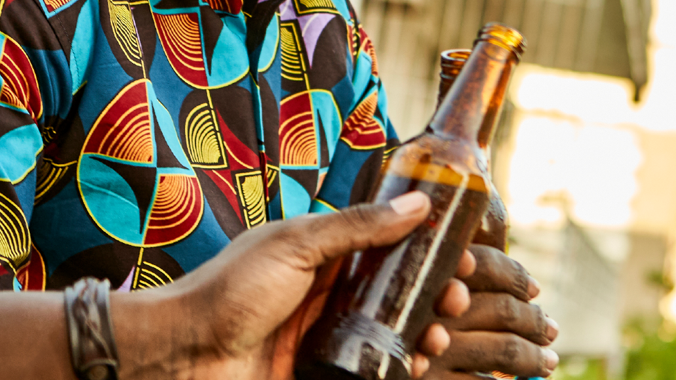 People holding beer bottles