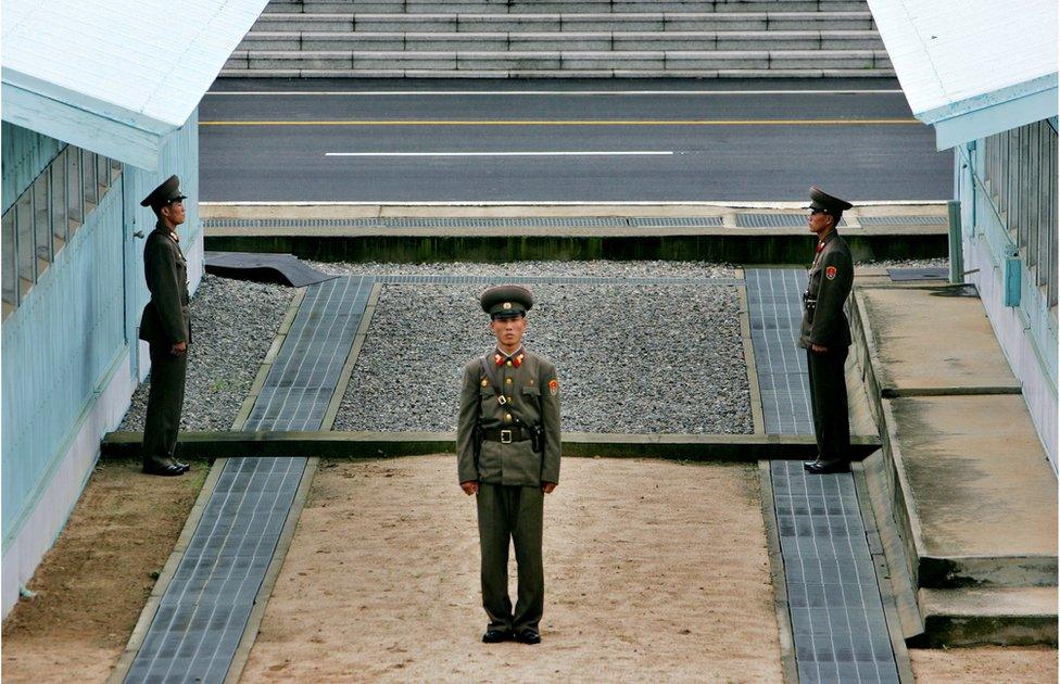 A North Korean soldier stands next to the demarcation line in Panmunjom, on the border between North Korea and South Korea Tuesday 7 August 2007