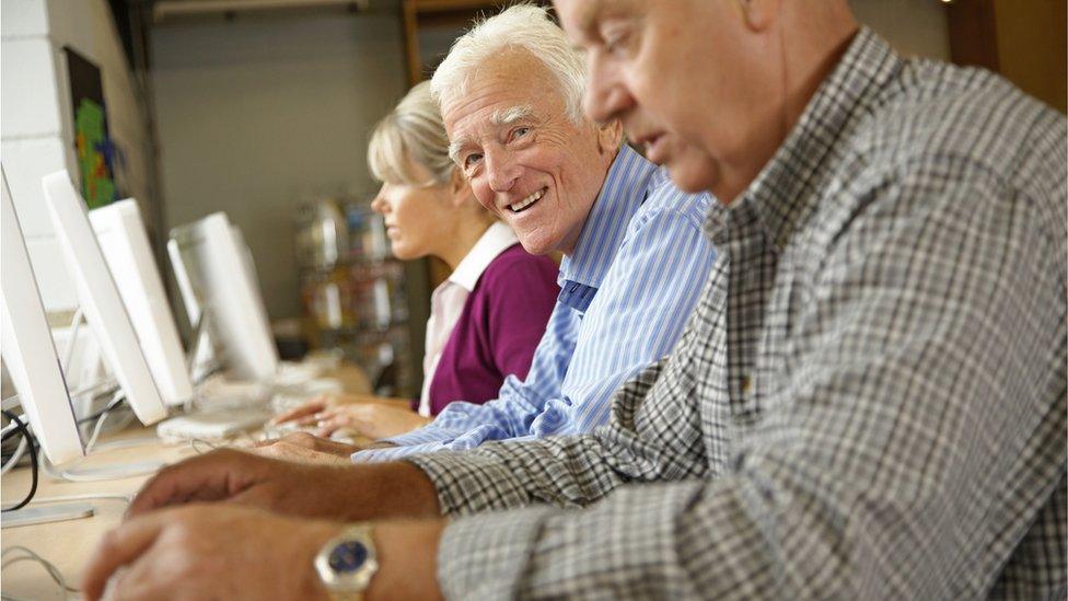 Elderly man in computer class