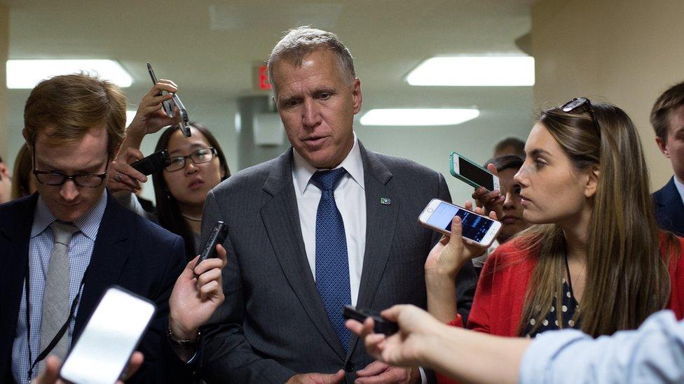 Thom Tillis speaks to reporters in the Capitol.