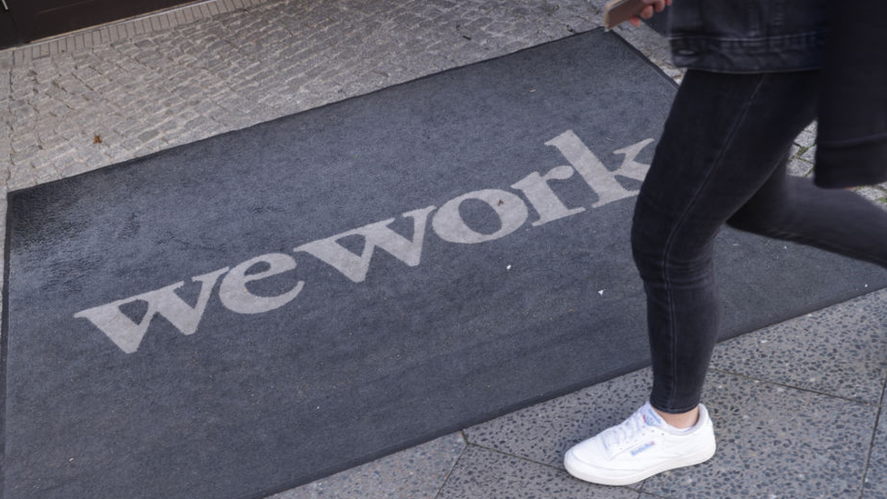 Person walks past WeWork entrance