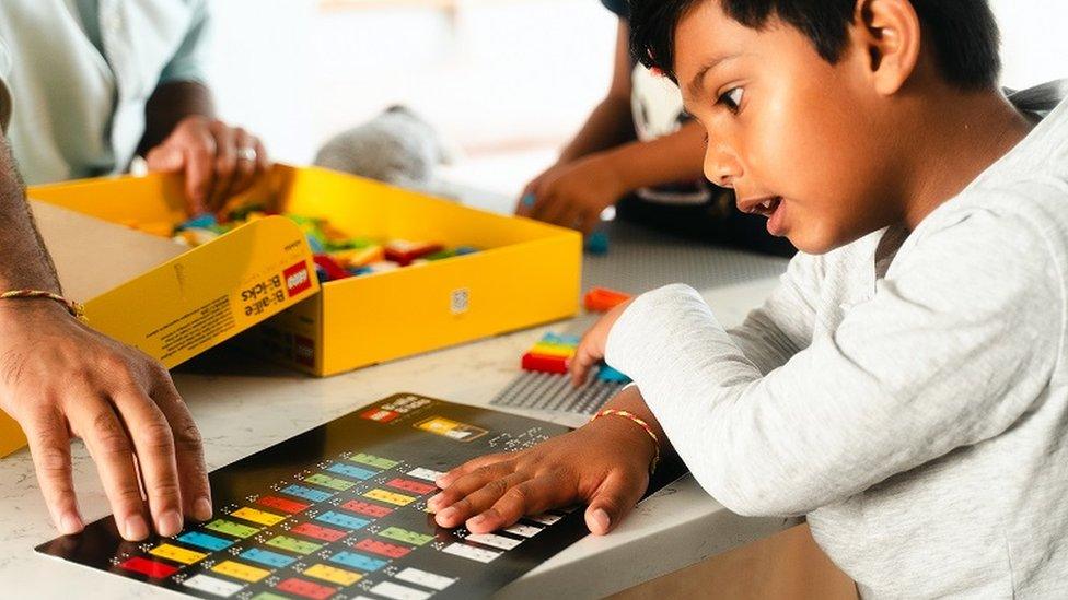 Boy studying braille chart