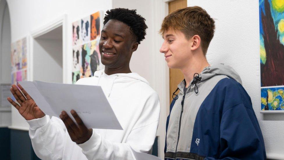 Two GCSE students stand next to each other