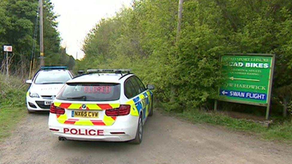 Police cars blocking road to venue