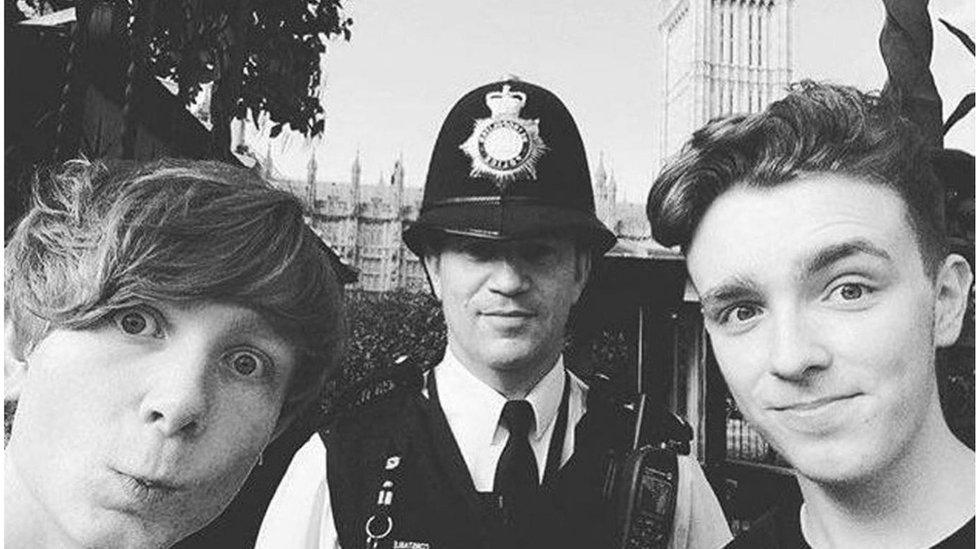 PC Keith Palmer stationed in front of the Houses of Parliament with Will, left, and Tyler, right.