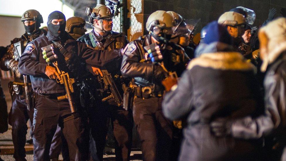 Police with large anti-riot weapons