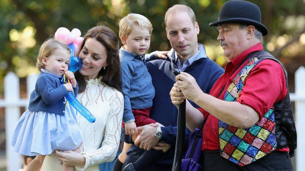 The Cambridges entertained by a man blowing balloons