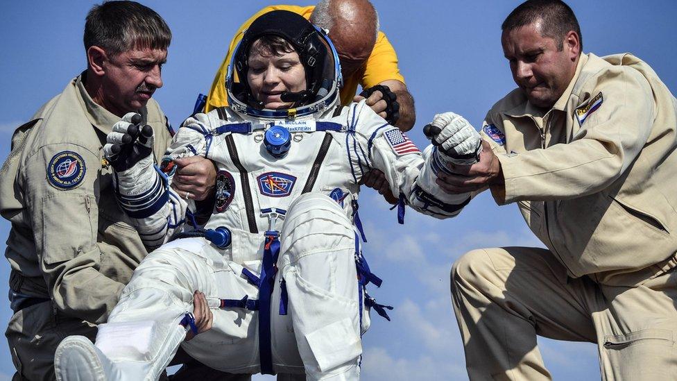 Ground personnel help NASA astronaut Anne McClain to get out of the Soyuz MS-11 capsule shortly after landing in a remote area outside the town of Dzhezkazgan (Zhezkazgan), Kazakhstan, on June 25, 2019.