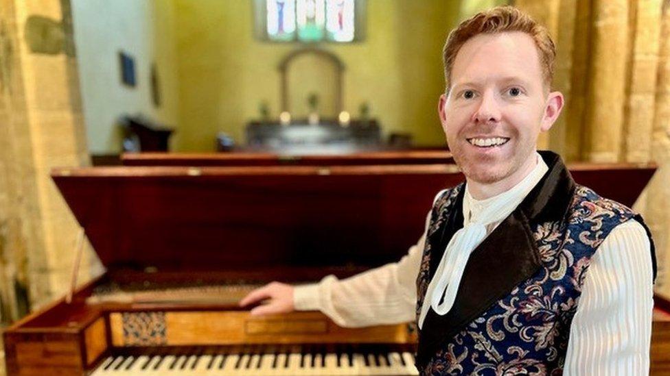 Jonthan Delbridge sitting at his square piano