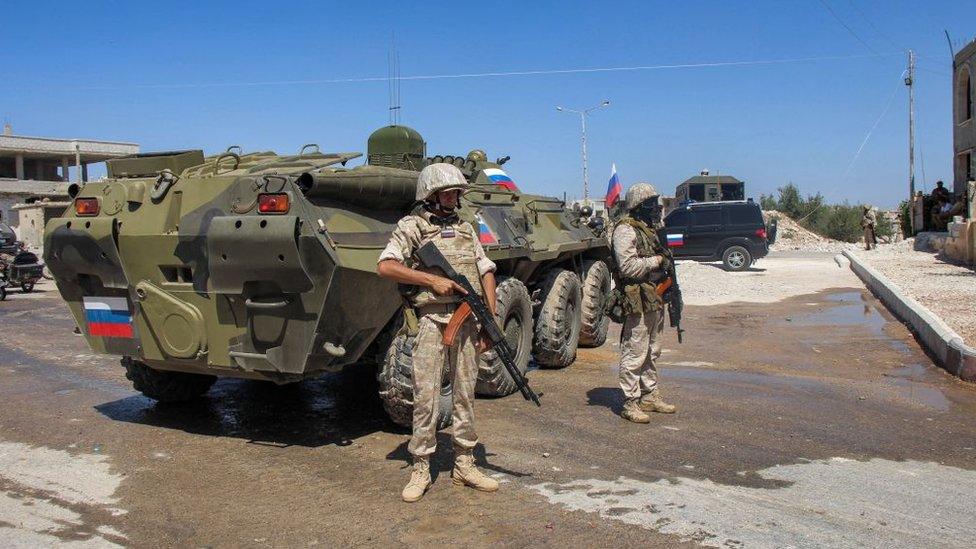 Russian soldiers stand by an armoured personnel carrier in the Deraa al-Balad area of Deraa city, Syria, on 6 September 2021