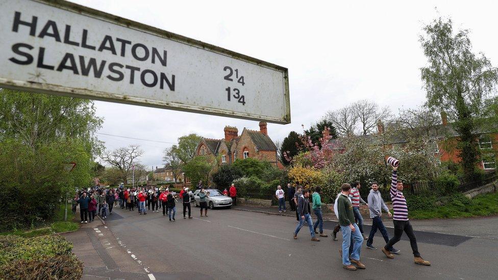 Villagers from Medbourne in Leicestershire parade a "bottle" through the village before their annual bottle kicking match with neighbouring Hallaton