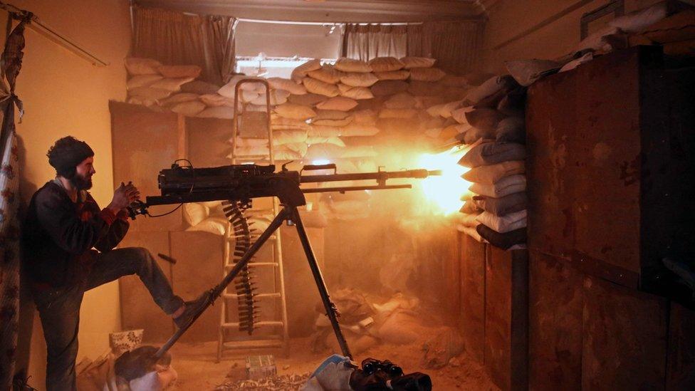 A rebel fighter from the Failaq al-Rahman group fires a machine-gun at government forces in eastern Damascus (19 March 2017)