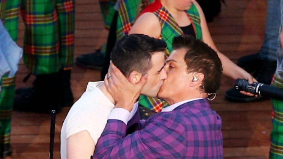 Two men kissing