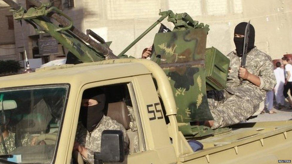 Heavily-armed Islamic State fighters drive through Raqqa, Syria (30 June 2014)