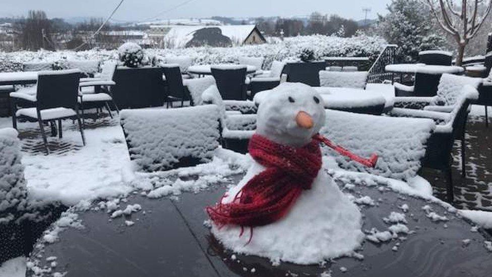 Mini snowman on an outside table