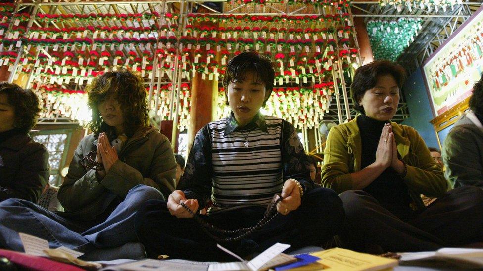 Parents pray for their children during their exams in Korea