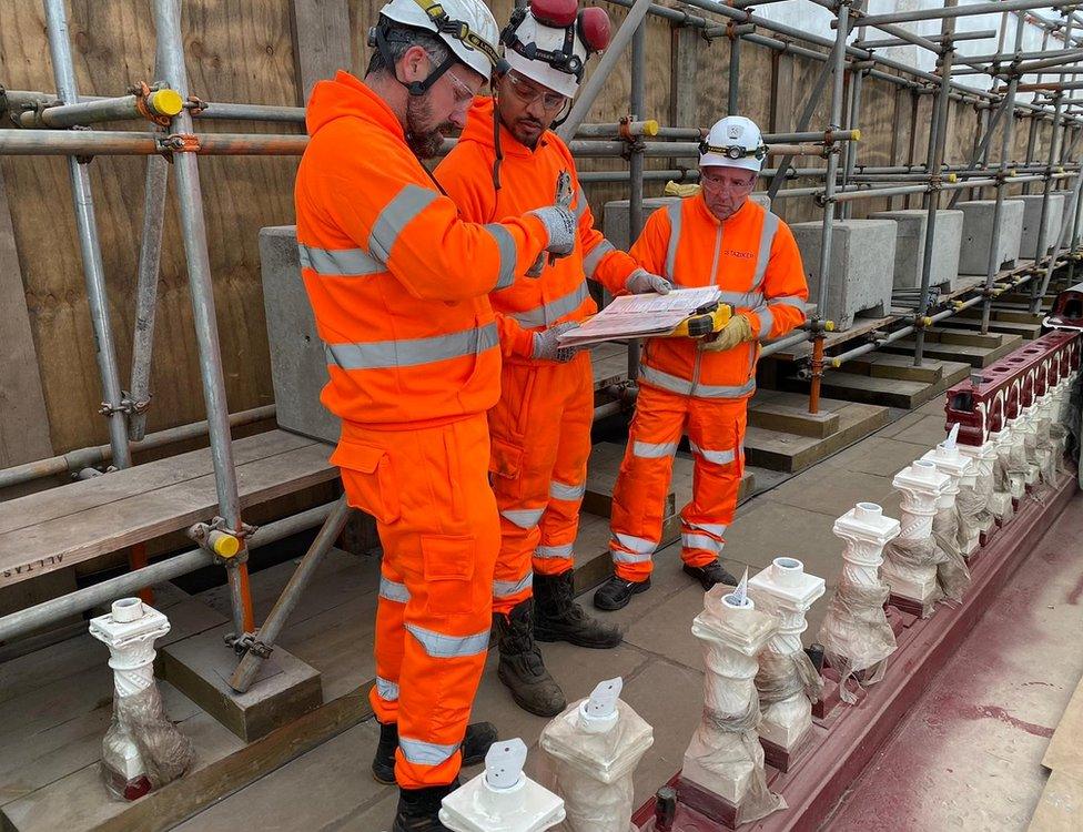 Workers tagging balusters