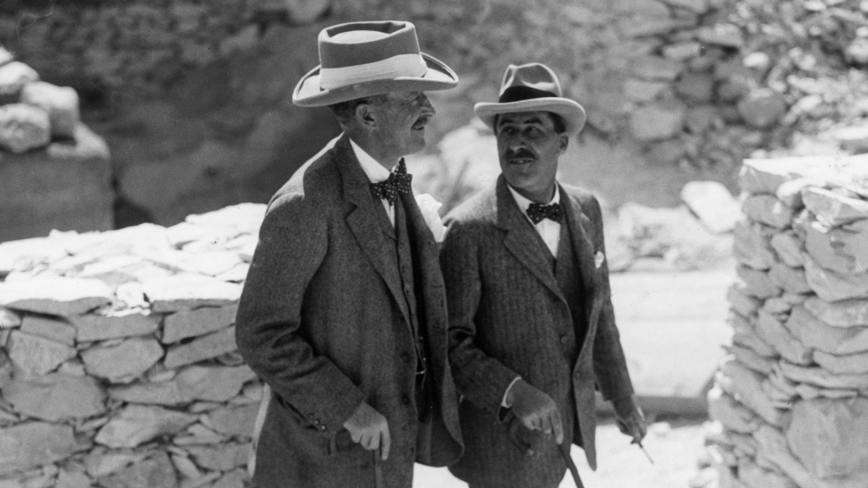 English Egyptologist Howard Carter (1874 - 1939, right) walks with the patron of his research, archaeologist and 5th Earl, Lord Carnarvon George Herbert (1866 - 1923), at the Valley of the Kings excavation site, Egypt.