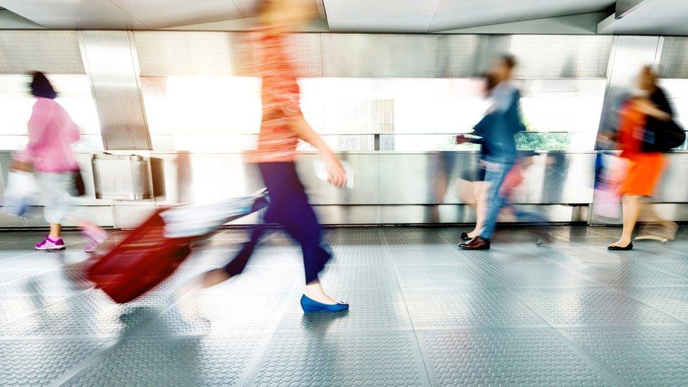 People walking through airport.