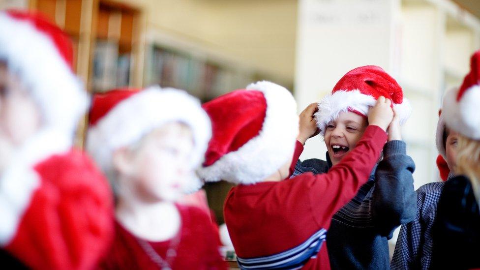 School children in Santa outfits.