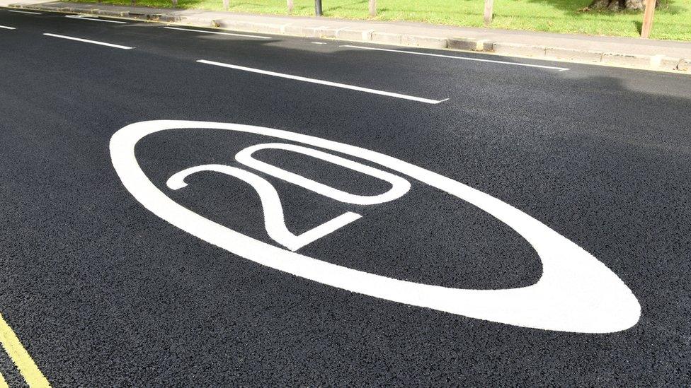 20 mph sign painted on road