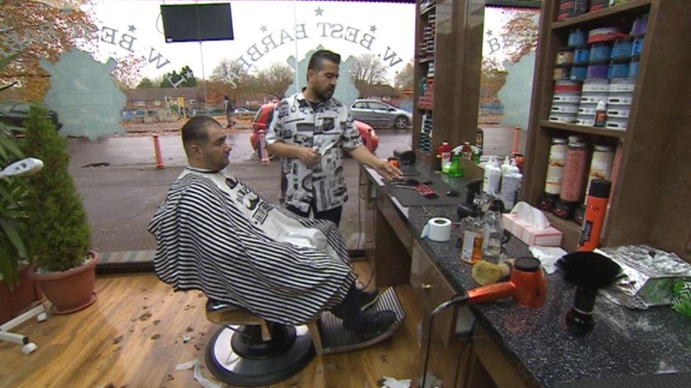 Kawa Hamed - Barber in Lawrence Weston - with a client in his barber shop