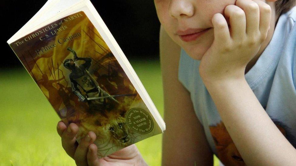 Anonymous child reading a book