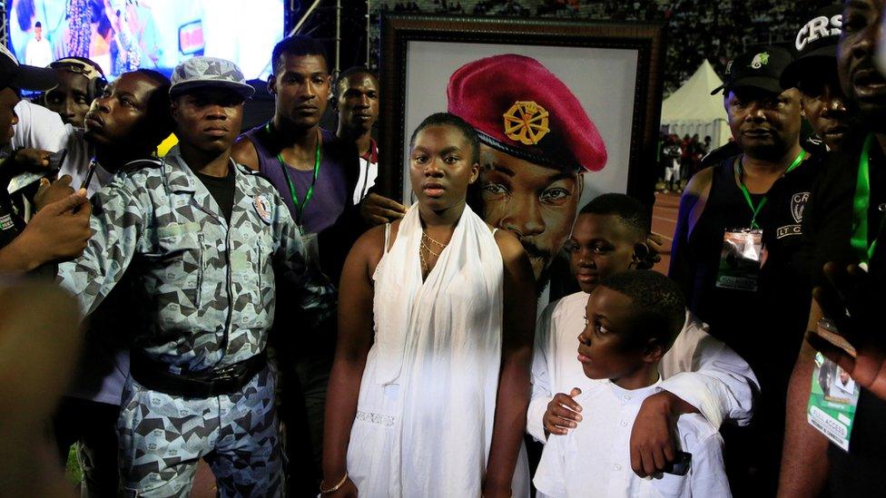 The children of late Ange Didier Houn, also known as DJ Arafat, attend a tribute ceremony