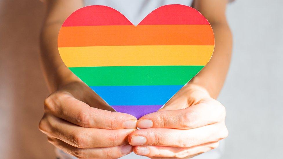 woman-holding-a-rainbow-heart