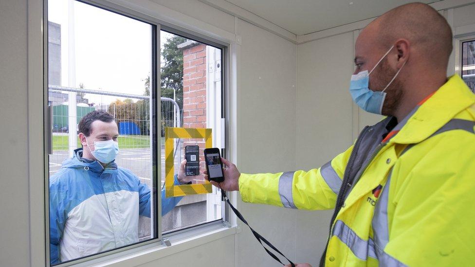 A man gets his app QR code scanned at a walk-in testing centre