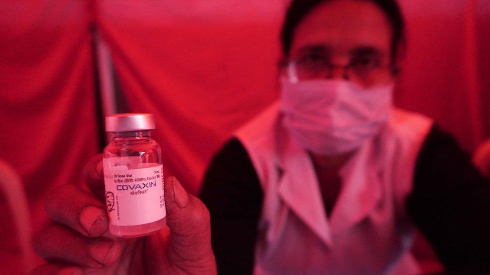 A healthcare worker shows a vial containing doses of COVAXIN, a coronavirus (COVID-19) vaccine, manufactured by Bharat Biotech, during a special vaccination camp in New Delhi, India on November 25, 2021.