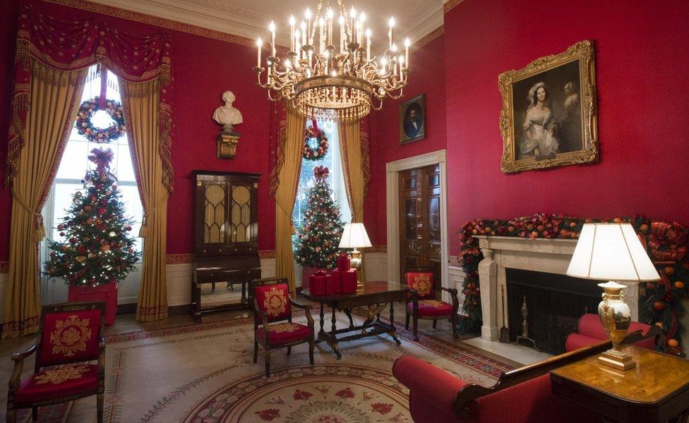 Christmas trees and holiday decorations in the theme of, 'The Gift of the Holidays,' are seen in the Red Room of the White House in Washington, DC, November 29, 2016