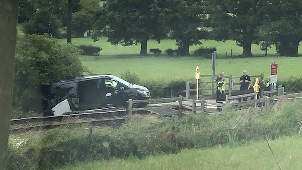 A black van was struck by a train near Welshpool