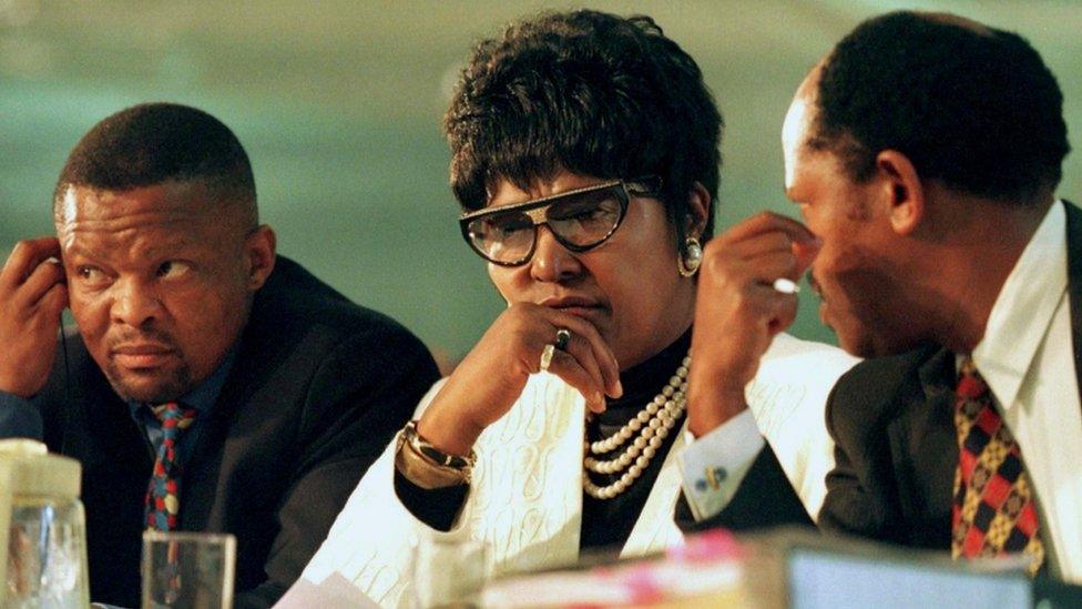 Winnie Madikizela-Mandela and members of her legal team listen to the testimony of one of the witnesses at a special public hearing of South Africa's Truth and Reconciliation Commission in 1997