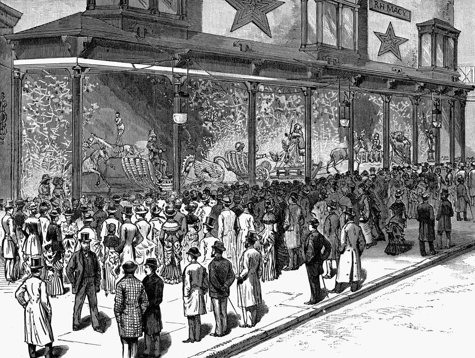 Crowds view Macy's highly decorated Christmas windows in a wood engraving from an American newspaper in 1884