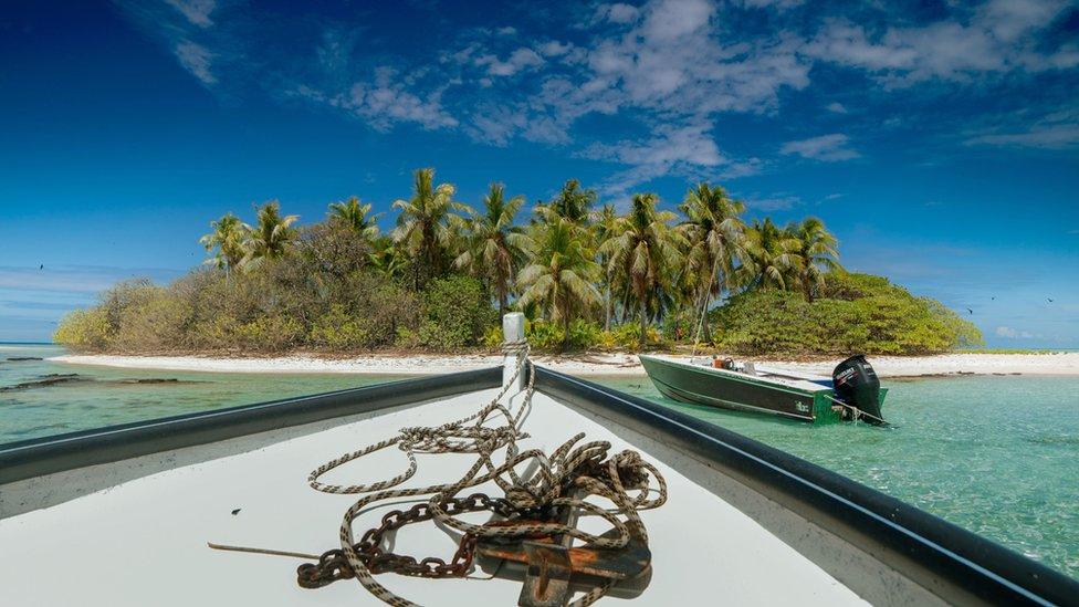 A boat approaches the Tagoi Motu near the Toau atoll, about 400 kilometres (250 miles) from Tahiti in the Tuamotu Archipelago in the French Polynesia, 4 October 2015.