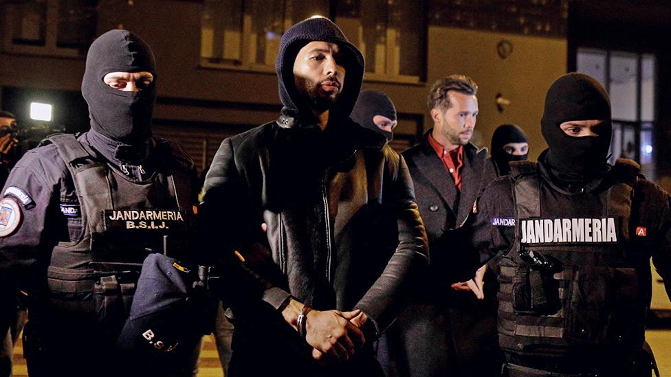 Andrew Tate and Tristan Tate are escorted by police officers outside the headquarters of the Directorate for Investigating Organized Crime and Terrorism in Bucharest (DIICOT) after being detained for 24 hours, in Bucharest, Romania, December 29, 2022.