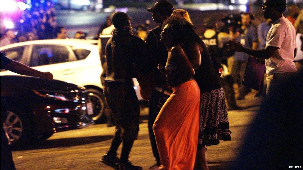 A woman screams in grief after shots were fired in a police-officer involved shooting in Ferguson, Missouri August 9, 2015.