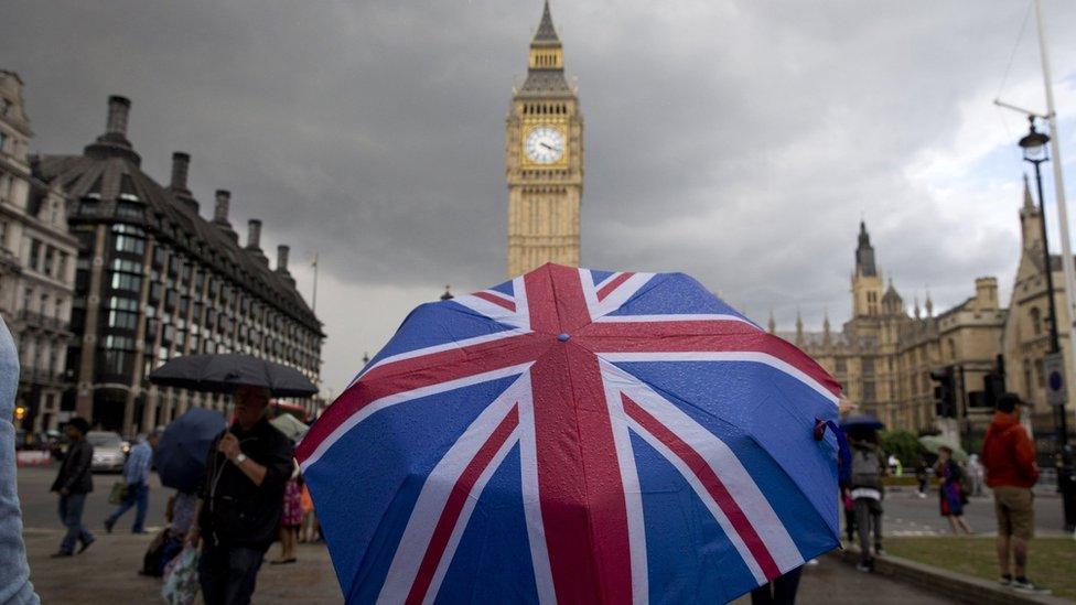 Union flag themed umbrella near Big Ben at the Houses of Parliament in central London on June 25, 2016,