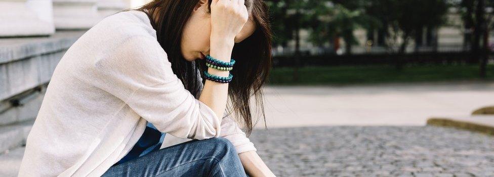 Young girl sitting in the street