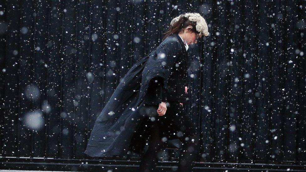 A barrister in Belfast makes her way to court through the blizzard