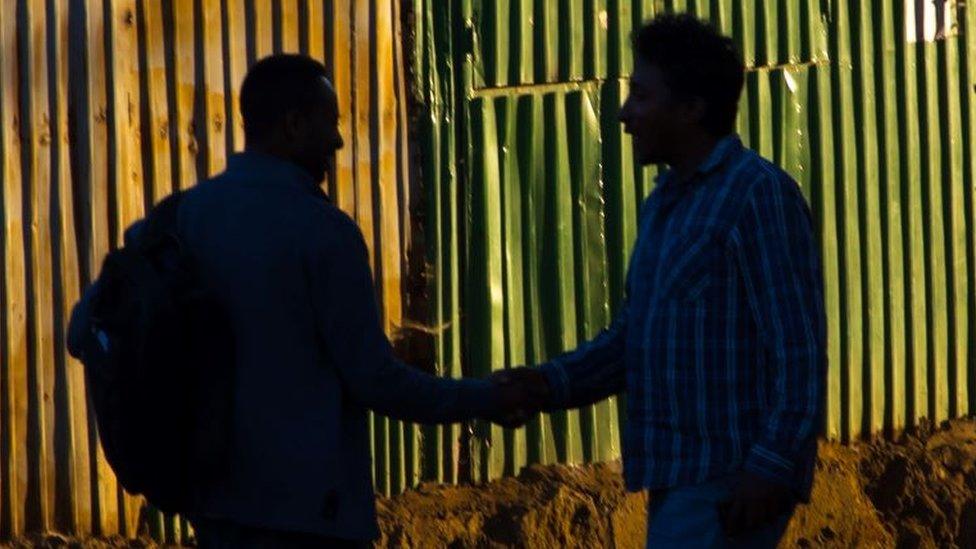 The silhouettes of two people in Addis Ababa