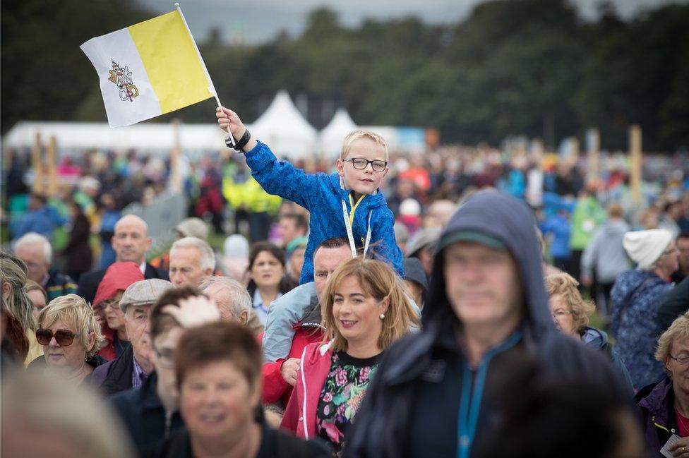 A boy waves a papal flag in Phoenix Park in Dublin