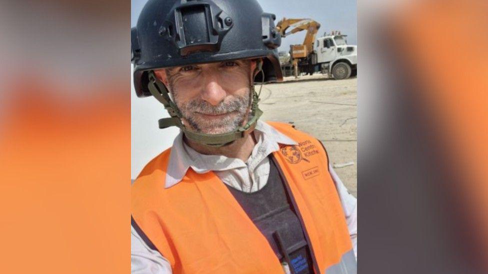 James Kirby in an orange World Central Kitchen jacket and hard hat