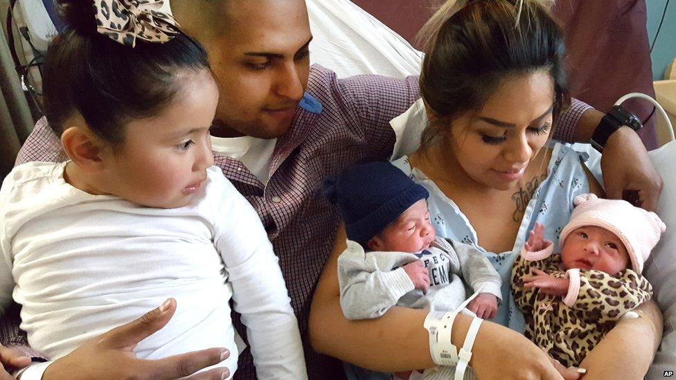 Mum Maribel holding twins Jaelyn and Luis with sister Isabella and dad Luis looking on