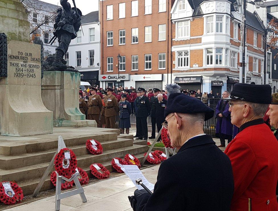 Veterans stand at the war memorial