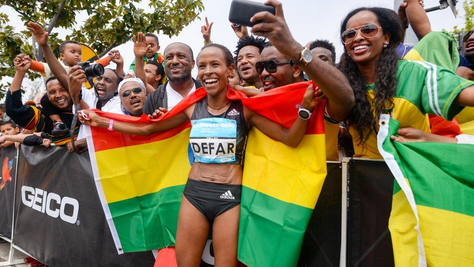 Ethiopian runner Meseret Defar draipped in the Ethiopian flag posing for photos in Carlsbad, California, the US - Sunday 3 April 2016