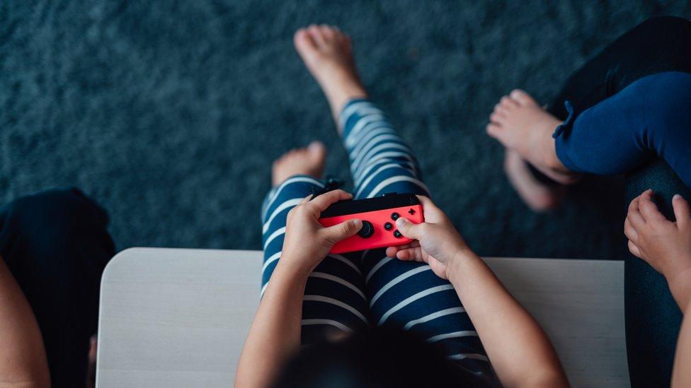 Child holding a game controller