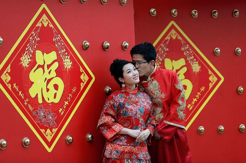 A couple dressed in traditional Chinese costumes have wedding portraits made on Valentine's Day 14 February 2013 in Beijing, China.