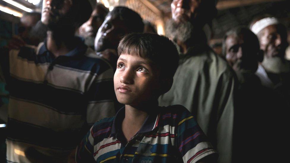 Rohingya refugees watch ICJ proceedings at a restaurant in a refugee camp